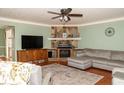 Cozy living room featuring a fireplace, built-ins, and a comfortable sectional sofa at 103 New Hood Rd, Stockbridge, GA 30281