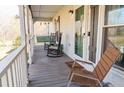 Inviting screened porch with rocking chairs, creating a relaxing outdoor space at 103 New Hood Rd, Stockbridge, GA 30281