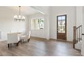 Bright dining room showcasing wood floors, a decorative light fixture, and paneled accent walls at 3315 Hillshire Dr, Cumming, GA 30028