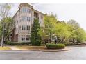 Attractive multi-story condo building featuring lush landscaping and mature trees on a tree lined street at 3635 E Paces Ne Cir # 1209, Atlanta, GA 30326