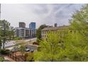 View from condo overlooking a street with mature trees and other condo buildings in the neighborhood at 3635 E Paces Ne Cir # 1209, Atlanta, GA 30326