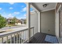 Inviting front porch with white railing, overlooking the street, and offering a warm welcome at 5925 Pine Bluff Dr, Cumming, GA 30040