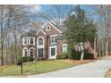 Brick home with an inviting front yard and a winding driveway at 2405 Castlemaine Ct, Duluth, GA 30097