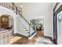 Grand foyer with a staircase, hardwood floors, and views into the dining and living rooms at 2405 Castlemaine Ct, Duluth, GA 30097