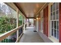 Spacious covered porch with wood columns and railings offering a cozy outdoor space at 2611 Rock Point Ln, Snellville, GA 30039