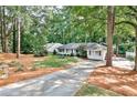 View of the exterior with an extended driveway and a lush lawn at 1309 Brookshire Ne Ln, Brookhaven, GA 30319