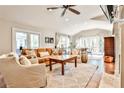 Bright living room features a ceiling fan, neutral colors, and French doors to outside at 1309 Brookshire Ne Ln, Brookhaven, GA 30319