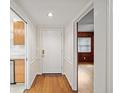 Hallway features hardwood floors, white trim and moulding, and doorway views of the kitchen and living areas at 1323 Christmas Ne Ln, Atlanta, GA 30329