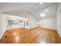Spacious living room featuring hardwood floors, a vaulted ceiling, and abundant natural light, creating a welcoming space at 1323 Christmas Ne Ln, Atlanta, GA 30329
