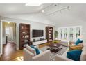 Bright living room with vaulted ceilings, hardwood floors, and French doors leading to the outside at 1323 Christmas Ne Ln, Atlanta, GA 30329