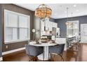 Modern kitchen with a central island, seating, stainless steel appliances, and sleek white cabinetry at 2013 Rockledge Ne Rd, Atlanta, GA 30324