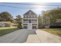 Charming two-story home with a covered porch, set amidst lush trees and an extended driveway at 2525 Reed Se St, Smyrna, GA 30080