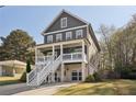 Charming two-story home with a covered porch, set amidst lush trees and an extended driveway at 2525 Reed Se St, Smyrna, GA 30080