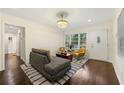Bright living room with hardwood floors, a comfortable sofa, armchairs, and natural light from the windows at 2903 Akron Street, East Point, GA 30344