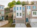 A modern three-story townhome with a painted brick facade and an attached garage at 399 Skylar Way, Atlanta, GA 30315