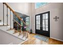 Inviting foyer with hardwood floors, staircase, and large front door with glass panels at 4103 Devon Wood Ne Dr, Marietta, GA 30066