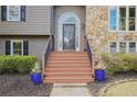 Close up of front door, showcasing the stairs, stone detail, and landscaping at 434 Shepard Sw Dr, Marietta, GA 30064