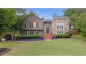 Charming two-story home with stone accents, landscaped lawn, and inviting entryway at 434 Shepard Sw Dr, Marietta, GA 30064
