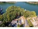 Expansive aerial view showcases the property and lake access surrounded by mature trees at 6160 Lake Lanier Heights Rd, Buford, GA 30518