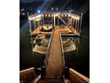 Illuminated boat dock at night with a boat and jet ski ready for water adventures at 6160 Lake Lanier Heights Rd, Buford, GA 30518