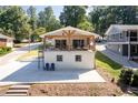 Charming home with a white brick exterior and a spacious covered patio overlooking the yard at 6160 Lake Lanier Heights Rd, Buford, GA 30518