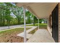 Covered front porch with white pillars and view of the front yard and street at 700 Thomasville Se Blvd, Atlanta, GA 30315