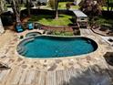 Gorgeous backyard with private in-ground pool, stone surround, spa, and wooden deck at 1643 Cumberland Trce, Acworth, GA 30102