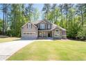 Charming two-story home with neutral siding, stone accents and an attached garage at 2050 Heritage Green Dr, Marietta, GA 30064