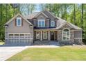 Charming two-story home with neutral siding, stone accents and an attached garage at 2050 Heritage Green Dr, Marietta, GA 30064