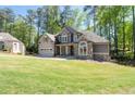 Charming two-story home with neutral siding, stone accents and an attached garage at 2050 Heritage Green Dr, Marietta, GA 30064