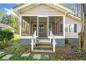 Inviting front porch with flower pots and weathered stairs leading up to a screen door entry at 434 Mac Johnson Nw Rd, Cartersville, GA 30121
