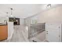 Bright living room featuring hardwood floors, modern fixtures, fireplace, and a staircase at 294 Arnold Mill Rd, Woodstock, GA 30188