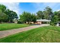 Lush lawn and mature trees complement the exterior of this well-maintained home at 3925 Orchard Se Rd, Smyrna, GA 30080