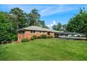 Well-manicured lawn and mature trees surround this beautiful brick home at 3925 Orchard Se Rd, Smyrna, GA 30080