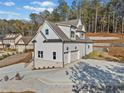 Beautifully crafted home with white siding, brick base, and spacious two-car garage at 52 Lake Overlook Dr, White, GA 30184