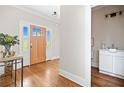 Bright foyer with hardwood floors, wooden front door, and view of the powder room at 52 Lake Overlook Dr, White, GA 30184