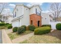 Charming two-story home with a brick entryway and lush landscaping at 102 Manley Ct, Woodstock, GA 30188