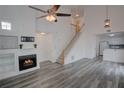 Bright, open-concept living room featuring high ceilings, fireplace, and hardwood floors at 102 Manley Ct, Woodstock, GA 30188