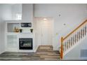 Cozy living room with a fireplace, TV, built-in shelving and a beautiful staircase with wood and white spindles at 102 Manley Ct, Woodstock, GA 30188