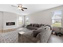 Spacious living room with a modern fireplace, plush seating, and lots of natural light at 1052 Bodega Loop, Locust Grove, GA 30248