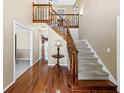 Welcoming foyer featuring hardwood floors, stairs with carpet, and natural lighting at 3227 Heritage Way, Buford, GA 30519