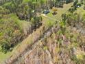 Expansive aerial view of a beautiful property with a home surrounded by lush greenery and mature trees at 5660 Trout Creek Dr, Douglasville, GA 30135