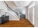 Bright foyer featuring a staircase, hardwood floors, an entryway table, and direct access to a sunny living room at 710 Greystone Ne Park, Atlanta, GA 30306