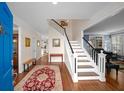 Inviting foyer with hardwood floors, staircase, and views into adjacent rooms at 710 Greystone Ne Park, Atlanta, GA 30306