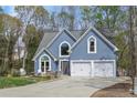 Charming home featuring a well-manicured lawn, two-car garage, and attractive curb appeal at 1007 Springharbor Walk, Woodstock, GA 30188