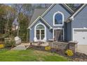 This home offers a well-manicured lawn, charming patio, and attractive curb appeal at 1007 Springharbor Walk, Woodstock, GA 30188