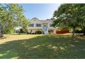 Attractive home with a spacious front yard and mature trees providing shade and curb appeal at 3540 Owl Brow Ct, Cumming, GA 30028
