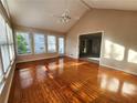 Bright sunroom with hardwood floors, multiple windows, vaulted ceilings, and a ceiling fan at 2875 Oak Meadow Dr, Snellville, GA 30078