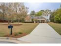 Lovely home with stone and siding, featuring a neatly kept lawn and a welcoming driveway at 135 Clear Spring Lane, Oxford, GA 30054