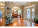 Inviting foyer with gleaming hardwood floors and an arched entryway to the formal dining room at 135 Clear Spring Lane, Oxford, GA 30054